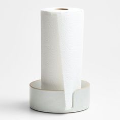 two rolls of white toilet paper sitting on top of each other in front of a white background