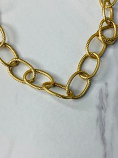 Our Unhinged large oval link chain is finely textured with a soft pale gold tarnish proof electroplate. We added a large CZ crystal carabiner clasp which also serves as a charm holder. Measures 22” long and is free from cadmium, lead, and nickel. Gold-tone Chunky Chain Necklace With Oval Links, 14k Gold Tarnish-resistant Oval Link Necklace, Gold-tone Oval Link Paperclip Chain Necklace, 14k Gold-filled Yellow Gold Oval Link Necklace, Gold-plated Oval Link Necklace With Polished Finish, Charm Holder, Pale Gold, Custom Jewelry Design, Chain Link Necklace