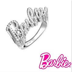 Elevate your style with our stunning 925 sterling silver Barbie ring. This exquisite piece features the word “Barbie” elegantly crafted in sparkling gemstones, creating a dazzling and glamorous accessory perfect for any fashion-forward individual. The ring’s intricate design and shimmering details make it a standout piece in any jewelry collection. Shipping:Takes 5-8 business days depending on stock, these beautiful rings are custom sized and made in small batches. If your size is in stock this item will ship immediately Product Details: Material: 925 Sterling Silver Gemstones: Clear Cubic Zirconia Design: Sparkling “Barbie” lettering Finish: Polished Size: Adjustable Occasion: Everyday wear, parties, and special occasions Why Choose This Ring? Elegance: The combination of sterling silver Luxury Sparkling Rings For Party, Glamorous Bling Rings For Formal Occasions, Glamorous Formal Rings With Bling, Luxury Sparkling Party Rings, White Gold Fine Jewelry Rings For Party, Glamorous Silver Ring For Party, Sparkling Sterling Silver Ring For Party, Glamorous Party Rings With Sparkling Stones, Luxury Party Diamond Ring With Sparkling Stones