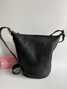 Vtg Coach Original  Helen's Legacy Duffle Bag Black leather with brass hardware Roomy interior with slip pocket Secured with a top zipper Detachable, adjustable 48" strap Measures: 11"H, 12.5"L, 7"W Made in Turkey #H6I-9953 Cleaned, conditioned and ready to wear! Questions? Just ask More vtg coach styles/colors also available g90 Vintage Hobo Bag With Zipper For Travel, Formal Bucket Bag With Brass Hardware, Vintage Hobo Bag With Gold-tone Hardware, Classic Bucket Shoulder Bag With Brass Hardware, Classic Bucket Bag With Brass Hardware, Classic Bucket Satchel With Adjustable Strap, Classic Bucket Bag With Snap Closure, Classic Rectangular Hobo Bag With Snap Closure, Vintage Bucket-shape Travel Bag