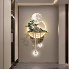 a wall mounted clock that has a bonsai tree on it and lights around the clock