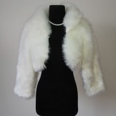 Material: Faux fur Color: Ivory Size: One size fits all It is made of high-quality artificial fur.the coat is very beautiful, comfortable to wear, and the long fluff is extremely warm. Shipping time: 20 working days We accept returns. Washing not supported. Elegant Cream Faux Fur Coat, Fitted Cream Faux Fur Coat, Elegant Winter White Faux Fur Coat, Elegant Faux Fur Outerwear With Feather Trim, Elegant Winter White Faux Fur Outerwear, White Faux Fur Outerwear With Feather Trim, Winter White Fitted Faux Fur Coat, Fitted Winter White Faux Fur Coat, Elegant White Fluffy Fur Coat