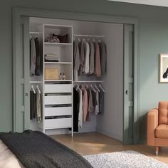 an open closet with clothes hanging on the wall and a chair in front of it