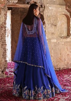 Elevate your style with Blue Embroidered Silk Lehenga Set. Crafted from luxurious habutai silk, this mesmerizing ensemble is adorned with intricate hand embellishments. The stunning blouse dazzles with sequins, pearls, crystals, glass beads, zari, and floral appliqué. Completed with a delicate net dupatta. Perfect for Mehendi, Sangeet ceremonies, or as a wedding guest. Complete the look with statement jewellery and heels for a truly enchanting appearance. Composition : Blouse & Lehenga - Habutai Silk, Dupatta - Net Care: Dry Clean Only and Vacuum Storage This product can be customized for sleeves, length and colour Delivery : 4-6 weeks as the product is hand crafted. Check Size Guide or choose MySize for free customisation (All Sizes above XL can be made at 15% additional cost) For more in Tissue Silk Palazzo Set With Zari Work, Traditional Blue Sets With Sheer Dupatta, Blue Sets With Sheer Dupatta In Traditional Drape, Traditional Drape Palazzo Set With Resham Embroidery, Traditional Drape Tissue Silk Palazzo Set With Resham Embroidery, Blue Traditional Drape Sets With Sheer Dupatta, Embellished Blue Palazzo Set For Reception, Blue Silk Palazzo Set With Intricate Embroidery, Navratri Embellished Chanderi Sharara