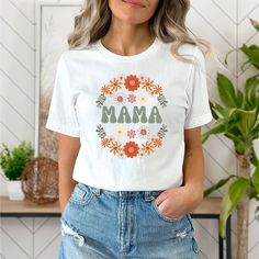 The perfect shirt for any Mama or Mama to be! sizes- small - 3XL This classic unisex jersey short sleeve tee fits like a well-loved favorite. Soft cotton and quality print make users fall in love with it over and over again. These t-shirts have-ribbed knit collars to bolster shaping. The shoulders have taping for better fit over time. Dual side seams hold the garment's shape for longer.  .: 100% Airlume combed and ringspun cotton (fiber content may vary for different colors) .: Light fabric (4.2 oz/yd² (142 g/m .: Retail fit .: Tear away label .: Runs true to size Mother's Day Floral Print Crew Neck T-shirt, Spring Custom Print Tops, Mother's Day Shirt With Custom Print And Relaxed Fit, Relaxed Fit Shirt With Custom Print For Mother's Day, Funny Print Short Sleeve Shirt For Mother's Day, Mother's Day Pre-shrunk Cotton T-shirt, Pre-shrunk Cotton T-shirt For Mother's Day, Cotton Short Sleeve T-shirt For Mother's Day, Mother's Day Floral Print Short Sleeve Top