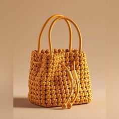 Polyurethane Removable Crossbody Strap One Inner Zip Pocket Drawstring Closure Dimensions 6.5"H, 6.5"L, 5"D 4.5" Handle Drop 19-24" Strap Drop Chic Yellow Crochet Bag For Daily Use, Chic Yellow Crochet Bag, Chic Yellow Crochet Tote Bag, Yellow Crochet Bag With Braided Handles For Shopping, Yellow Tote Bucket Bag With Braided Handles, Yellow Bucket Bag With Braided Handles For Daily Use, Spring Yellow Bucket Bag With Adjustable Strap, Yellow Crochet Bucket Bag For Summer, Yellow Bucket Crochet Bag For Summer