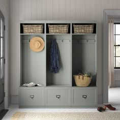 a white coat rack with baskets and shoes