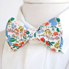 "Dapper Men's Wild Rose In Cream Metallic Bow Tie Made By The Belle And The Beau! ♥ This beautiful cotton floral fabric is part of our new Primavera Collection designed by Rifle Paper Co! We have been approved by Rifle Paper Co to make our products in these fabrics- that means we will be ordering bolts regularly! Yay! Our dapper, modern, stylish, and charming neckties are perfect for everyday, Sunday best, all special occasions, photography sessions, and especially dapper on grooms and groomsmen White Bow Tie For Spring, Groomsmen Bowtie, Floral Bow Tie, Wedding Order, Tie Men's, Dapper Men, Preppy Look, Mens Bow Ties, Southern Wedding