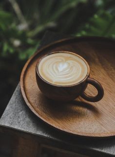 a wooden tray with a coffee cup on it