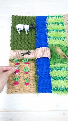 someone is stitching together different colored knitted items