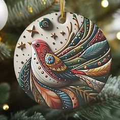 an ornament hanging from a christmas tree decorated with colorful feathers and star decorations