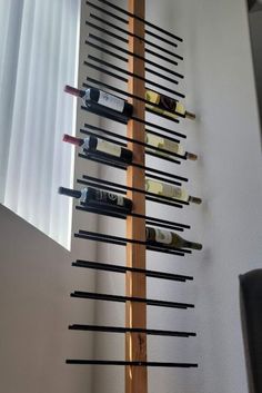 a wine rack made out of wooden sticks