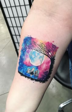 a person with a tattoo on their arm and the image of a tree is painted in watercolor