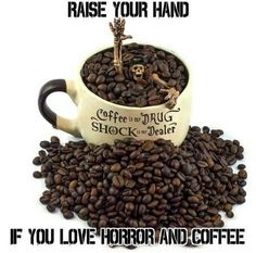 a coffee cup filled with coffee beans and the caption, raise your hand if you love horror and coffee