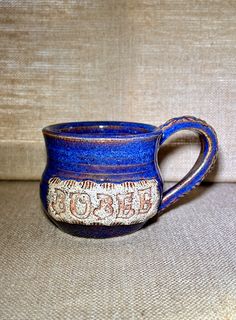 a blue mug with the word boo on it