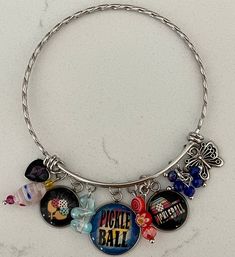 a bracelet with charms on it sitting on a table