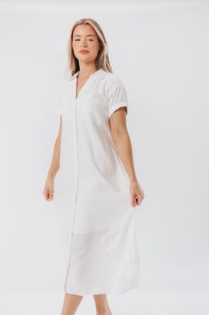 This midi dress just feels summer-ready. The Paris Shirt Dress features a classic collared neckline, with easy short sleeves and a flowy fit that will be an instant favorite. Add a belt and mules and you've aced everyday glamour. FIT: Runs true to size - relaxed fit. MATERIAL: 55% Linen, 45% Viscose. Machine wash cold. GARMENT DETAILS: Linen-blend shirt dress with collared V-neckline, button front placket, and chest pockets. Features cuffed short sleeves and in-seam side pockets. SIZE GUIDE: XS Elegant Summer Shirt Dress With Rolled Sleeves, Collared Midi Dress With Relaxed Fit For Summer, Summer Solid Collared Shirt Dress, Relaxed Fit Collared Midi Dress For Summer, Casual Button Front Midi Shirt Dress, Spring Relaxed Fit Shirt Dress For Daywear, Casual Midi-length Shirt Dress With Placket, Casual Midi Length Shirt Dress With Placket, Summer Relaxed Fit Shirt Dress For Work