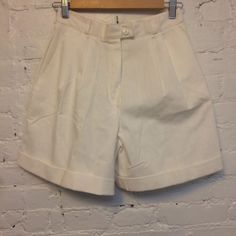 woven cotton or cotton blend  pleated, high waist cuffed hems side pockets has light wear and a tiny red mark at back(photo) otherwise, very good with light wear tag reads size 10, but is a small or 4-6 flat: slightly over 13" waist, 19.5" hip, 12" rise, 5" inseam we combine shipping. add to your cart before checkout for best fit compare the measurements to your clothing email us with any questions or concerns smoke and pet free. thank you for stopping Classic White High-waisted Bermuda Shorts, Retro White Shorts With Pockets, High-waisted White Cotton Bermuda Shorts, Classic White Cotton Bermuda Shorts, White High-waisted Cotton Bermuda Shorts, White High-waisted Bermuda Shorts In Cotton, Classic White Bermuda Shorts, Retro White Short Bottoms, Classic White Bermuda Shorts For Summer