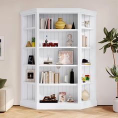 a white bookcase with many books on it