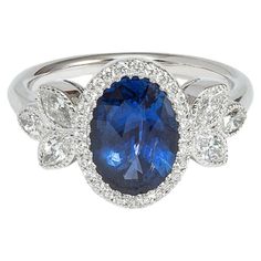 a blue and white ring with diamonds around it