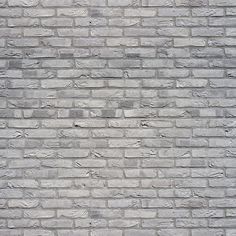 a brick wall that is made out of grey bricks