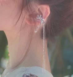 Sparkling no piercing silver ribbon ear cuff climber, with pearl and rhinestone dangles. Stylish punk street wear style, super chic and edgy. No ear hole necessary, easy to wear and adjust. Delicate cubic zircon paved on cute silver ribbon. Absolutely unique add on to your everyday outfit! , 💎 Features: ♥ Material: Silver plated copper ♥ Main stone: Faux pearl ♥ Side Stone: Rhinestone ♥ Adjustable ear cuff, no ear hole needed ♥ Sold as 1 piece 💎 Details: ♥ Approximate Measurements: - Length: 7.5 cm - Width: 2.3 cm ♥ Lightweight, easy to wear ♥ Nickel/Lead Free, Hypoallergenic, good for sensitive skins 🎁 Packing & Shipping: ♥ All our jewelry will be shipped with beautiful gift wrap packaging ♥ Handwrite gift notes/cards available upon request ♥ SAME DAY& FREE US Domestic Shipping availab Silver Cubic Zirconia Ear Cuff For Party, Cubic Zirconia Single Ear Cuff For Party, Single Cubic Zirconia Ear Cuff For Party, Elegant Sterling Silver Ear Cuff For Party, Party Cubic Zirconia Ear Cuff, Elegant Ear Climbers For Party, Elegant Single Ear Climber For Parties, Cubic Zirconia Ear Climbers For Party, Party Cubic Zirconia Ear Climbers