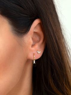 "Beautiful and classy, these tiny baguette hoop earrings are adorned with a dainty baguette charm. Layer these versatile huggie hoops with other delicate earrings to create your favourite ear stack. * Sold individually (1 hoop) or by pair (2 hoops). Both options are available on the dropdown menu. * Available with an emerald green, white or black cubic zirconia gemstone. All options are available on the dropdown menu. * D E T A I L S * ∙ Material: .925 Sterling Silver or 18K Gold Plated over .92 Earring Ideas 2 Holes, Double Ear Piercing Ideas Silver, 2 Ear Piercings Silver, Seconds Ear Piercing Silver, 2nd Hole Ear Piercing, Ear Piercings First And Second, Small Earlobe Piercings, Baguette Huggie Earrings, 2 Earrings Piercings Silver