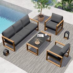 an outdoor living room with grey furniture next to a swimming pool