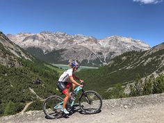 a man riding a bike on top of a mountain