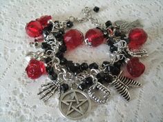 "This beautiful bracelet has red faceted beads, red glass rose beads, black czech glass beads, silver foil beads, sterling silver plated bead caps, pewter silver pentacle and pewter silver charms . 7\" long can be adjusted to 9\". Lobster clasp." Dragons Breath Fire Opal, Wicca Jewelry, Unicorn Bracelet, Goddess Bracelet, Rose Beads, Gothic Bracelet, Vampire Halloween, Glass Rose, Halloween Gothic