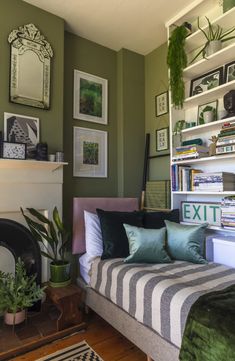 a living room filled with lots of furniture and pictures on the wall above it's fireplace