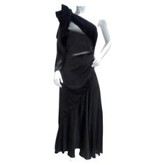 Introducing the Lanvin Haute Couture 1980s Velvet Bias Cut Black Gown, a breathtaking masterpiece that epitomizes timeless elegance and sophistication. This incredible gown showcases Lanvin's signature craftsmanship and attention to detail, making it a true statement piece. Crafted from luxurious black velvet, the gown features a bias cut that elegantly drapes and flares out at the bottom, creating a flattering silhouette that exudes grace and poise. The asymmetric one-sleeve style adds a modern Vintage Silk Gown For Formal Occasions, Vintage Evening Dress For Cocktail, Vintage Silk Party Gown, Vintage Cocktail Evening Dress, Vintage Silk Evening Dress, Vintage Silk Evening Dress For Gala, Vintage Floor-length Evening Gown, Vintage Evening Gown With Bias Cut, Vintage Bias Cut Evening Gown