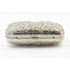 Elegant Judith Leiber silver metal and crystal oblong evening bag clutch featuring a scrolling foliage flower design on a silver - toned metal bag.  The hardware is silver.  It has a silver leather interior with a silver shoulder strap that can be folded inside when you want to wear it as a clutch.  There is a circle that folds out to hold a tassel, but it is no longer there.  Labeled ‘Judith Leiber/New York’ in the interior. 5.5” W x 3” H x 1.5” D  A similar one sold at Chrisities from Joan Riv Luxury Evening Clutch With Silver-tone Hardware, Luxury Formal Clutch With Silver-tone Hardware, Luxury Silver Clutch, Designer Silver Clutch For Formal Events, Designer Silver Clutch For Formal Occasions, Designer Silver Clutch With Silver-tone Hardware, Designer Silver Clutch For Events, Designer Silver Clutch For Event, Luxury Silver Clutch For Evening