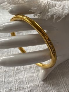 This is a lovely signed gold vermeil bangle bracelet, made in England. It is fully hallmarked , and in excellent, vintage condition. The bracelet is beautifully made, and weighs 60g. The bracelet measures 7 5/8 inches inside. It is perfect for a larger wrist. It is stylish and appropriate for a male or female. This bracelet was made in England in 1941. Multiple hallmarks. "14k gold vermeil over sterling silver. Impressed anchor and lion assay mark with maker's mark FR and capital letter script R Gold Bangle Stamped 14k As Gift, Gold-tone Polished Bangle As A Gift, Gold-tone Polished Finish Bangle For Gift, Gold-tone Polished Bangle Perfect For Gifts, Classic Gold Bangle Tarnish Resistant, Classic Gold-tone Bangle Bracelet, Elegant Brass Bangle For Everyday Wear, Elegant Everyday Brass Bangle, Timeless Gold Bangle With Polished Finish