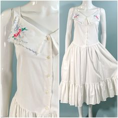 Vintage 70s white summer dress, strappy with embroidered collar.  Prairie/Hippie style, full skirt gathered below the waist, ruffled hem. Buttons up the front, darts on bodice. Relaxed fit, slightly dropped waist. Unlined, Cotton/Poly blend. Handwash OK.  *straps were pinned shorter on mannequin to show best fit.   LABEL: Avon Fashions, Made in USA.  CONDITION: Very good pre-owned vintage. handwashed, clean & ready to wear.  SIZE: Marked 7/8,  Refer to measurements for an accurate fit. All sizes Feminine Vintage Dress With Ruffles For Summer, Feminine Summer Vintage Dress With Ruffles, Spring Sleeveless Vintage Dress With Ruffles, Spring Vintage Sleeveless Dress With Ruffles, Vintage Maxi Dress For Summer Daywear, Summer Ruffles Vintage Dress For Daywear, Summer Vintage Ruffled Dress For Daywear, Summer Vintage Dress With Floral Embroidery, Vintage A-line Dress For Summer Daywear