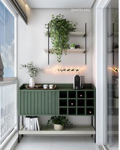 there is a green cabinet in the room with plants on it and a neon sign above