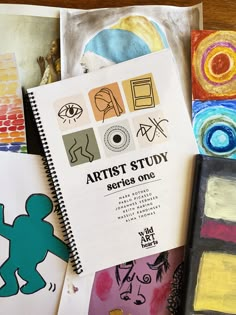 an artist's study book sitting on top of a table next to other art supplies