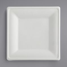 a white square plate on a gray surface