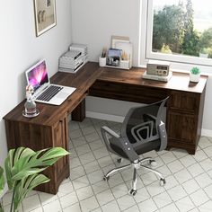 a computer desk with a laptop on it and a plant in front of the window