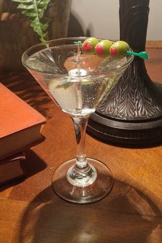 a glass filled with liquid sitting on top of a wooden table