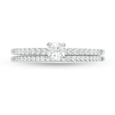 This 1/2 ct. t.w. diamond bridal set in 10K white gold features a 1/5 ct. diamond center stone engagement ring. A coordinating wedding band completes the look. White Solitaire Round Cut Bridal Sets, White Diamond Bridal Sets With Round Band, Center Stone Engagement Ring, Diamond Bridal Sets, Stone Engagement Ring, Stone Engagement Rings, Stone Engagement, Bridal Set, Bridal Sets