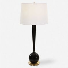 a black and gold table lamp with a white shade on the top, against a white background