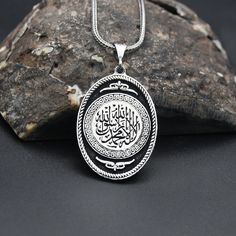 "Islamic Engraved Silver Necklace, Religous Necklace, 925 Sterling Silver Necklace, Charm With Chain Necklace, Handmade Necklace ✦ Details ✦ * Material: 925 Sterling Silver * Weight of pendant : 8,00  gram *  Chain Weight :     20 Inches = 5.00 Gr     22 Inches = 5.60 Gr     24 Inches = 6.05 Gr     26 Inches = 6.10 Gr     28 Inches = 6,40 Gr * Sides oxidized * Stamp: 925 ✦ Shipping ✦ * Processing time: 1-3 business days. * This item ships from my Turkish workshop in Istanbul. * Add your phone number in address box for a smoother delivery. That makes courier personnel's job easier.  ✦ Packaging ✦ * Comes with a luxury gift box and a jewellery cleaning cloth and courtesy gift. ✦ Returns, Exchanges ✦ * Return option available for 30 days after the delivery. * The product has to be in the same Spiritual Silver Oval Pendant Necklaces, Silver Spiritual Locket Jewelry, Silver Oval Amulet Necklace, White Gold Engraved Spiritual Necklaces, White Gold Engraved Spiritual Necklace, Silver Locket Jewelry For Blessing, Spiritual Oval Engraved Necklaces, Spiritual Engraved White Gold Necklace, Spiritual Oval Engraved Necklace