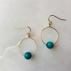 The Mini hoops feature a bright, colorful bead or gemstone of your choice on a round hoop that is wire-wrapped and secured to an elegant ear wire. These hoop earrings are mindfully made with high-quality, gold-plated metals. They are nickel-free and safe for sensitive ears. If you have additional allergies, please contact me before purchasing. I have sterling silver, gold-filled, or hypoallergenic titanium ear wires available by request. The earrings are approximately 1 3/4" long x 1" wide, incl Hoop Earrings With Round Natural Stones For Gift, Circular Beaded Earrings With Ear Wire For Gifts, Circular Beaded Earrings With Ear Wire As Gift, Gift Hoop Earrings With Natural Stones, Blue Small Hoop Earrings Wire Wrapped, Blue Small Hoop Earrings With Wire Wrapping, Blue Small Hoop Wire Wrapped Earrings, Blue Wire Wrapped Hoop Earrings, Blue Wire Wrapped Small Hoop Earrings