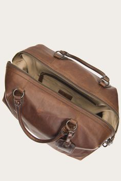 Crafted from rich pull up leather, the Logan Overnight boasts a sturdy, sophisticated silhouette ready to accompany an adventurous photojournalist on a trip through South Africa. Or at least out to the Hamptons. Handsome luggage tags and an interior pocket add comfortable convenience. - 13 1/4" height - 24 1/4" top width - 21" bottom width - 4 1/4" handle drop - Removable crossbody strap - Leather name tag - Two zip interior pockets - Zipper closure Oiled Leather Travel Bag With Leather Lining, The Frye Company, Bags For Men, Men's Bags, Overnight Bag, Pull Up, Shoes And Boots, Name Tag, Bags And Accessories