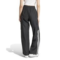 Wide legs make for comfortable days... The adidas Wide Leg Women's Cargo Pants give you plenty of room to move, along with handy cargo pockets to store your belongings. And with the iconic adidas stripes down the side, you can get the comfort and classic style the brand is known for.Features adidas three-stripe design. Relaxed fit. Elastic waistband. Features two cargo pockets. Material: 100% Polyester. Consists of at least 40% recycled materials. Contains 50% Parley Ocean Plastic. Functional Adidas Bottoms With Pockets, Adidas Bottoms With Pockets, Functional Adidas Bottoms For Jogging, Adidas Functional Jogging Bottoms, Functional Adidas Jogging Bottoms, Adidas Sporty Wide Leg Sweatpants, Adidas Sporty Sweatpants With Pockets, Sports Wide Leg Pants With Cargo Pockets, Adidas Joggers With Pockets For Sports