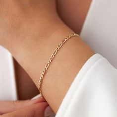 Our new simple and dainty Figaro chain bracelets, as always made in 14k solid gold. You can wear this bracelet with a free mind without worrying about water, perfume, or conditioner contact since real gold never tarnishes.★ Features of the Bracelet (this listing is for a single bracelet only)• Gold Kt: 14K Solid Gold (all pieces are stamped for authenticity)• Available Gold Color: Yellow Gold• Chain Width: 2.5 mm Single Bracelet, Gold Diamond Earrings Studs, Diamond Huggies, Solid Gold Bracelet, Water Perfume, Emerald Bracelet, Custom Bracelet, Free Mind, Gold Statement Ring