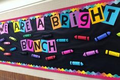 a bulletin board with crayons on it that says we are a bright bunch