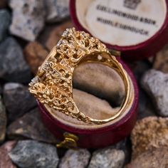 This vintage ring is centered with a replica of an 1852 $1 American gold coin set in a bezel. The coin is accented with eight round brilliant cut diamonds that are all prong set. The ring is crafted of 14k yellow gold and shows patina. It is currently a size 6.75. Collectible Gold Rings With Diamond Accents, Antique Gold Cluster Ring, Collectible Round Diamond Ring With Intricate Design, Gold Rings With Rose Cut Diamonds For Collectors, Gold Cluster Ring With Bezel Setting For Formal Occasions, Collectible 14k Gold Diamond Ring With Rose Cut Diamonds, Vintage Signet Ring With Prong Setting For Anniversary, Heirloom Yellow Gold Diamond Ring Collectible, Heirloom Yellow Gold Filigree Ring