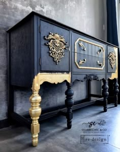 an ornate black and gold sideboard in a room